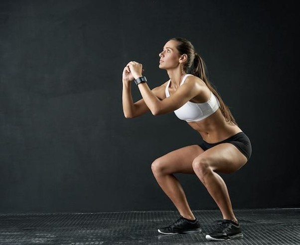 fitness squat and sports woman in studio for leg muscle exercise balance or strength on dark background strong athlete and female person for performance workout glutes training or body goals